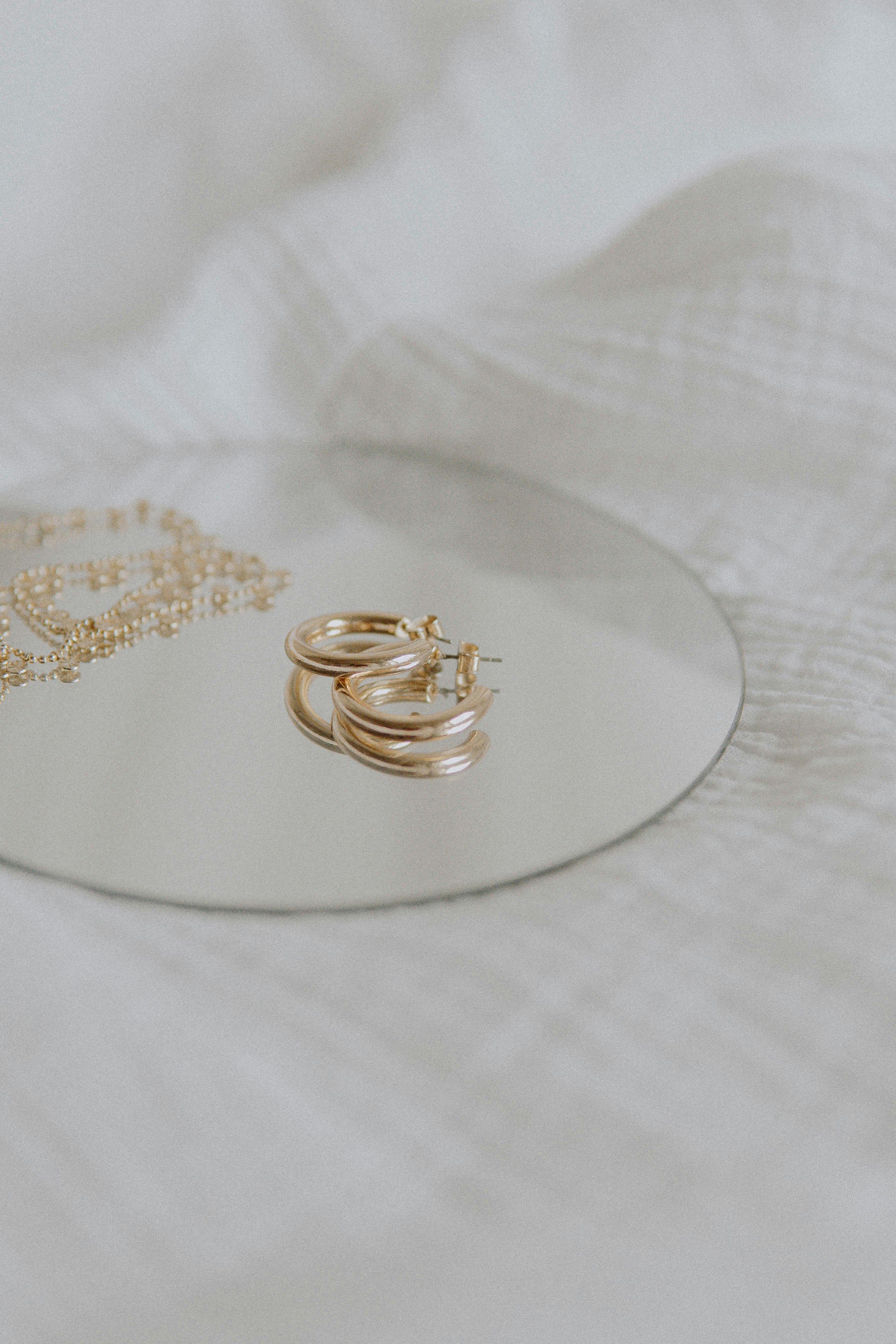 gold ring on white textile